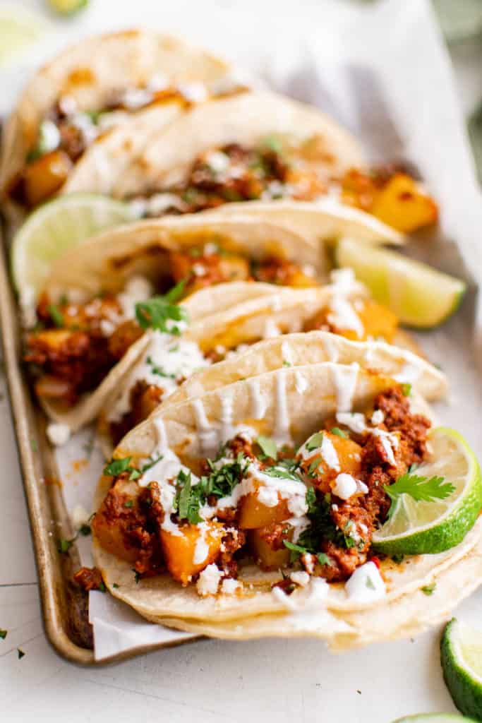 Side view of chorizo tacos with toppings.