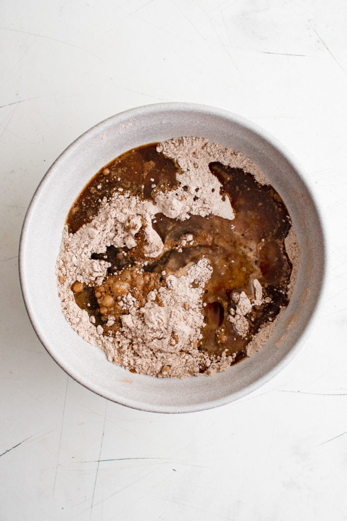 Dry cake batter in a bowl with coffee.