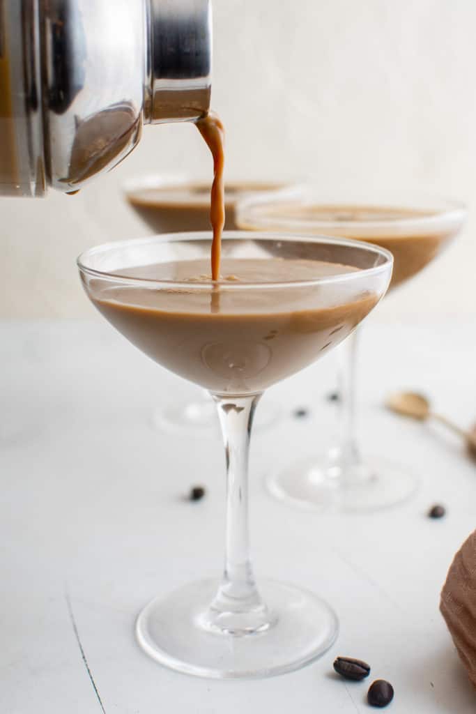 Espresso being poured into a martini glass.