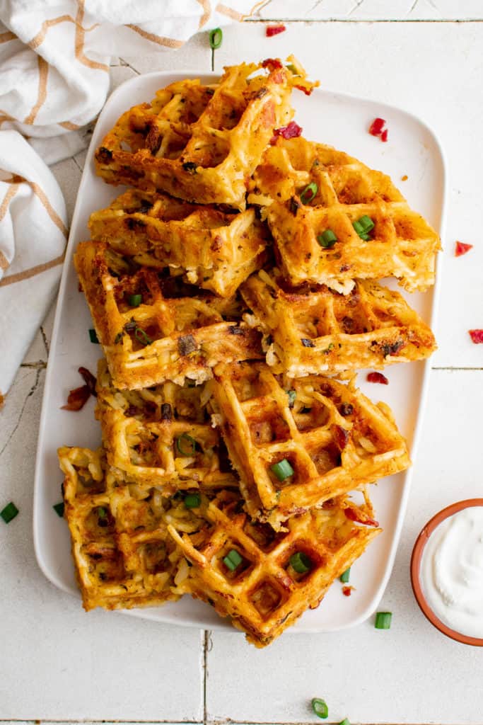 Top down view of hash brown waffles on a platter.