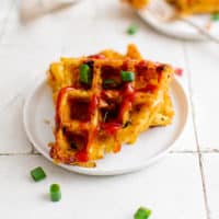 Two quarters of hash brown waffles on a plate.