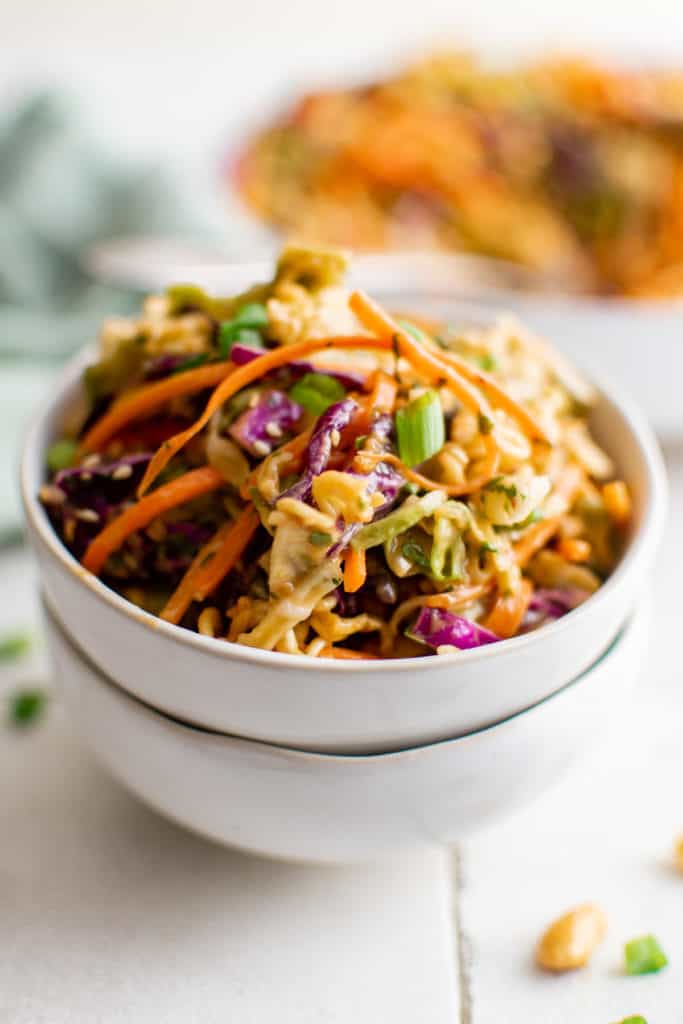 Two white dishes filled with noodle salad.
