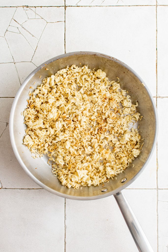 Cooked ramen noodles in a pan.