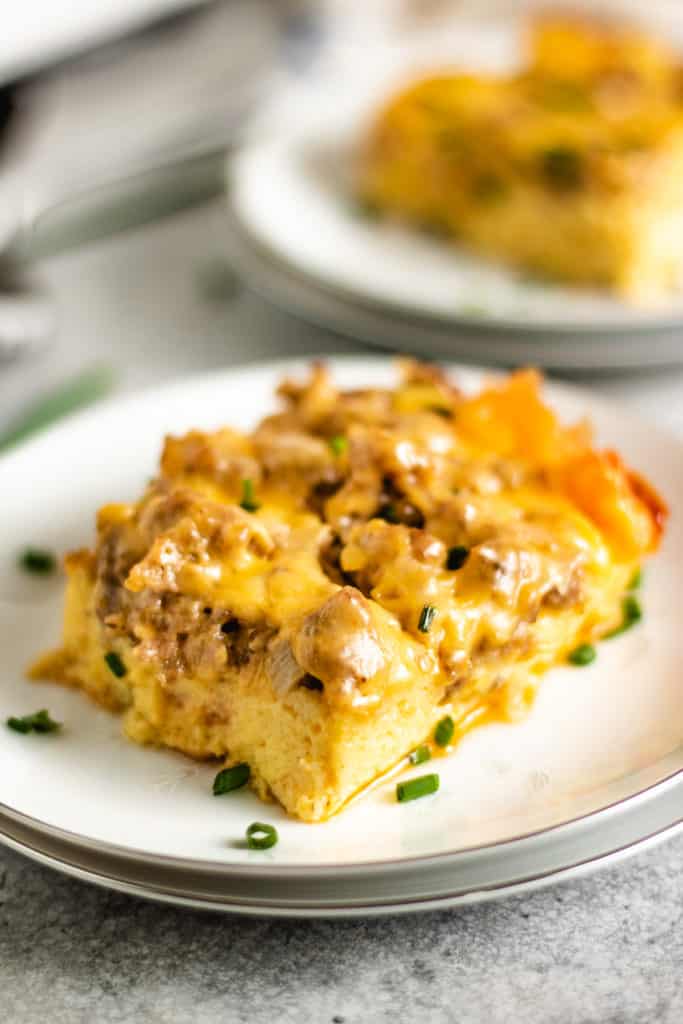 Sausage egg casserole topped with green onions and cheese.