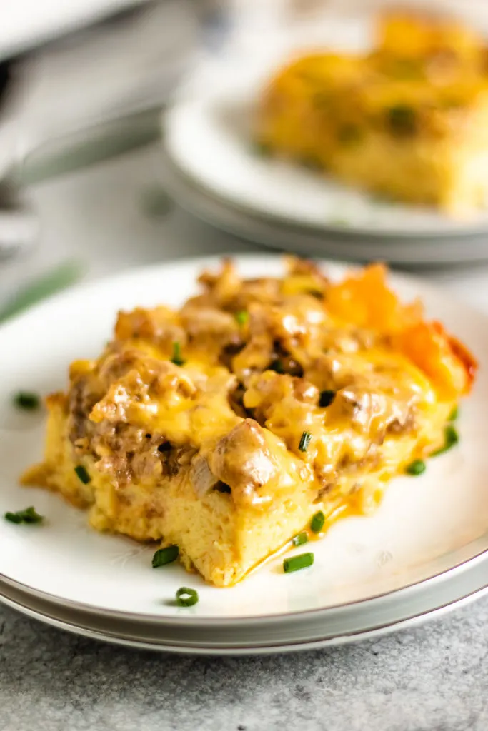 Sausage egg casserole topped with green onions and cheese.
