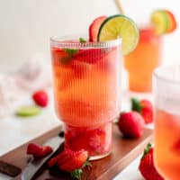 Glasses of strawberry mojito on a cutting board.