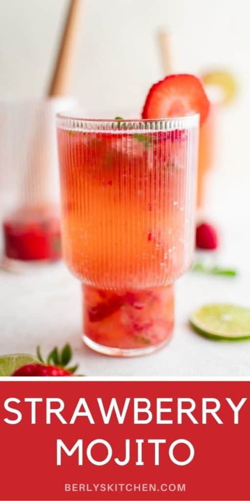 Tall glass filled with a strawberry mojito.