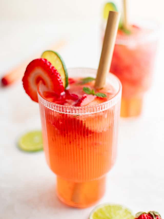 Glasses of strawberry mojito with straws.