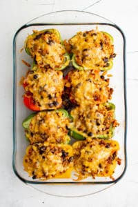 Top down view of stuffed bell peppers with melted cheese.