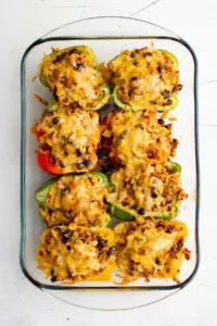 Top down view of stuffed bell peppers with melted cheese.