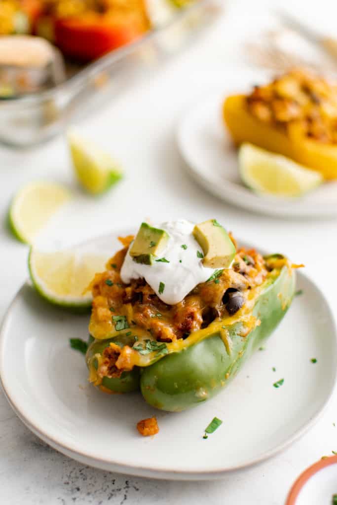 Green stuffed bell pepper on a plate.