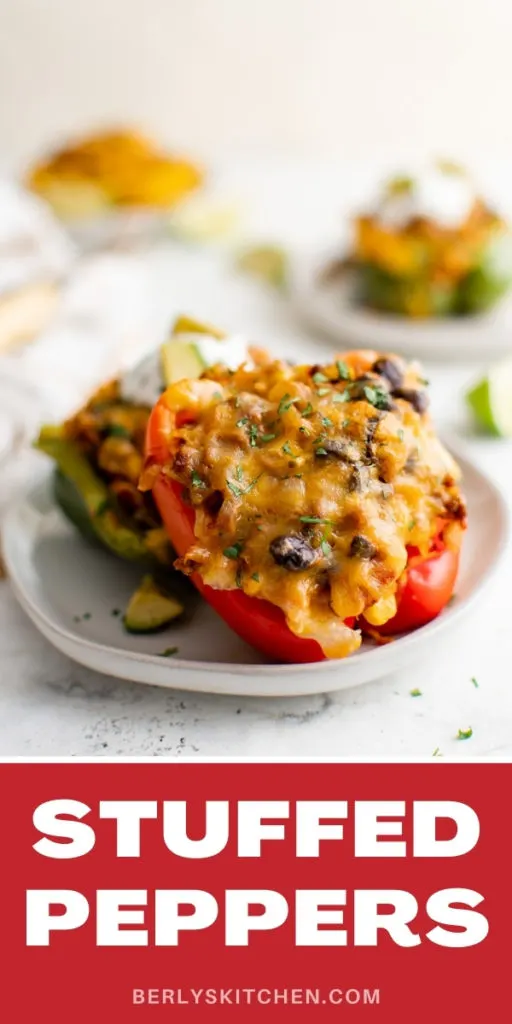 Red stuffed peppers on a gray plate.