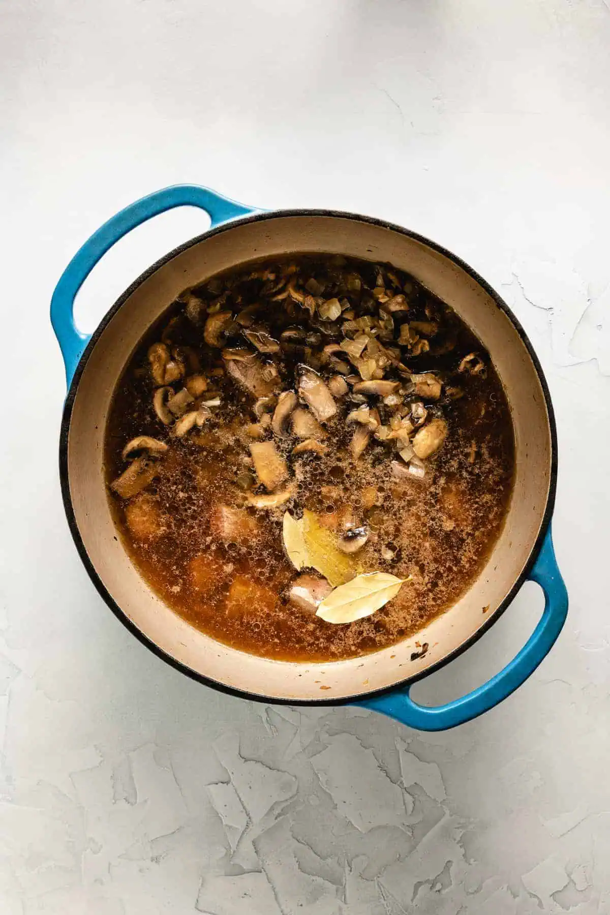 Cooked beef and mushrooms in broth.
