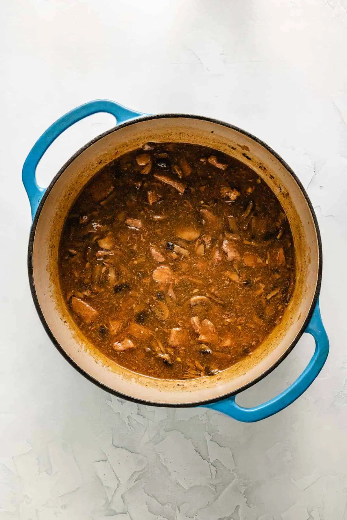 Beef tips and gravy in a Dutch oven.