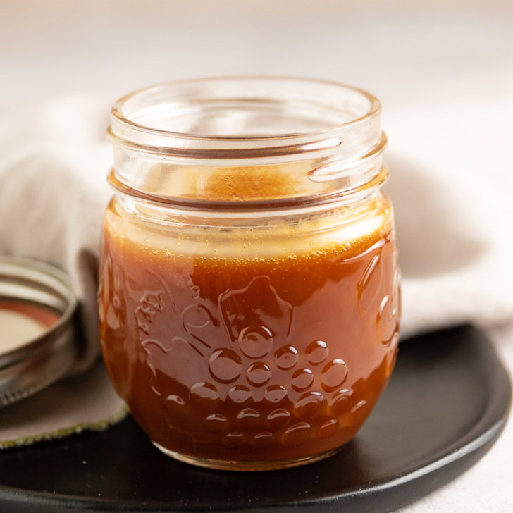 Caramel sauce in a mason jar.