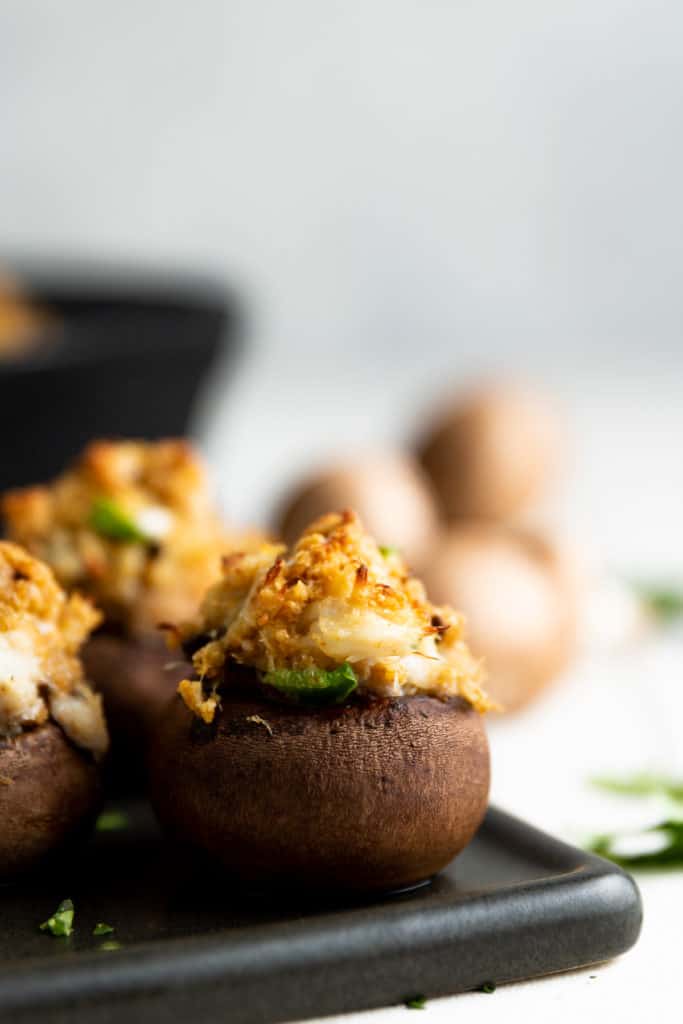 Close up of a stuffed mushroom on a platter.