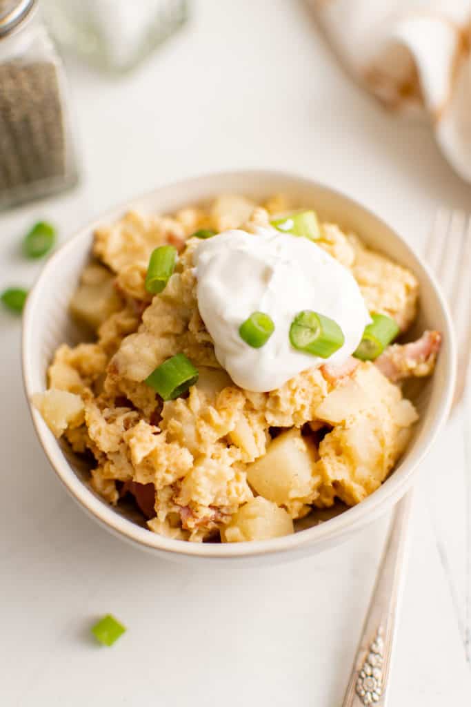 Close up view of farmer's casserole topped with sour cream.