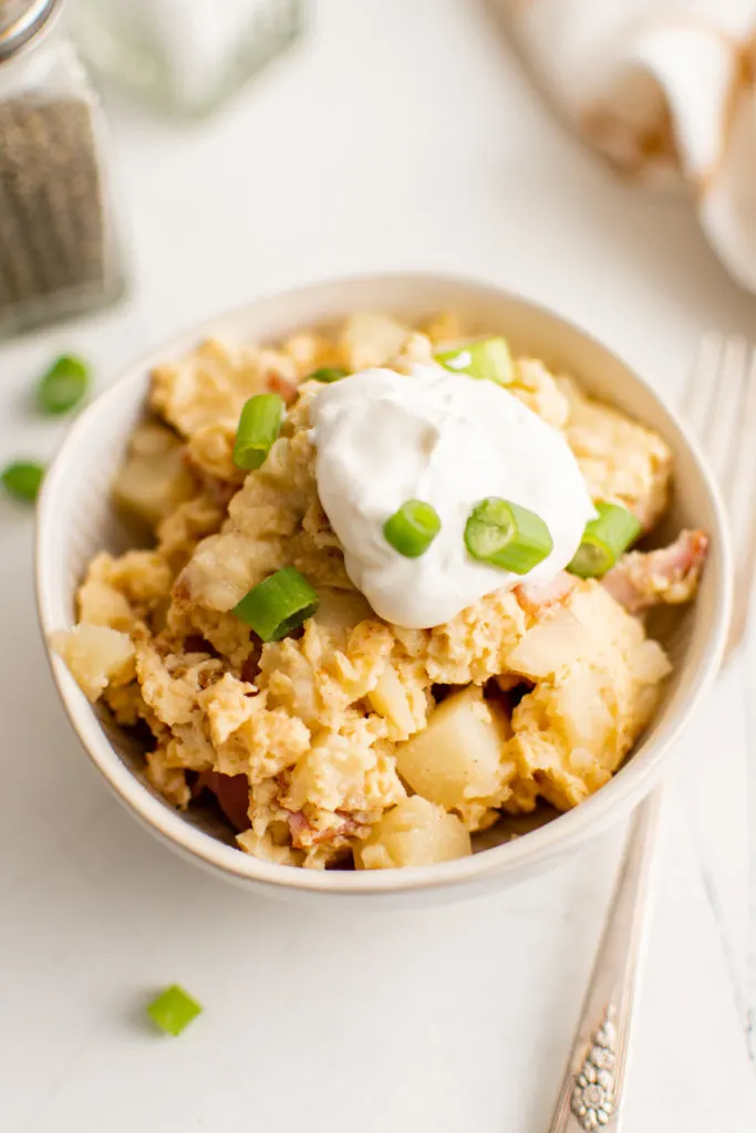 Close up view of farmer's casserole topped with sour cream.