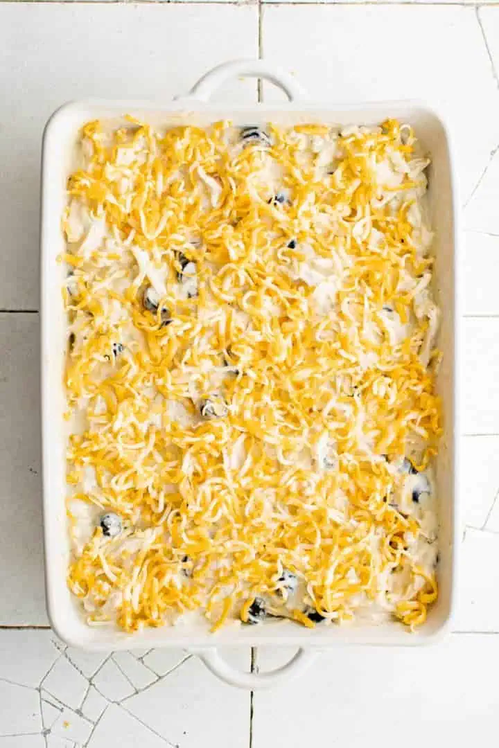 Top down view of a green chile chicken casserole with cheese.