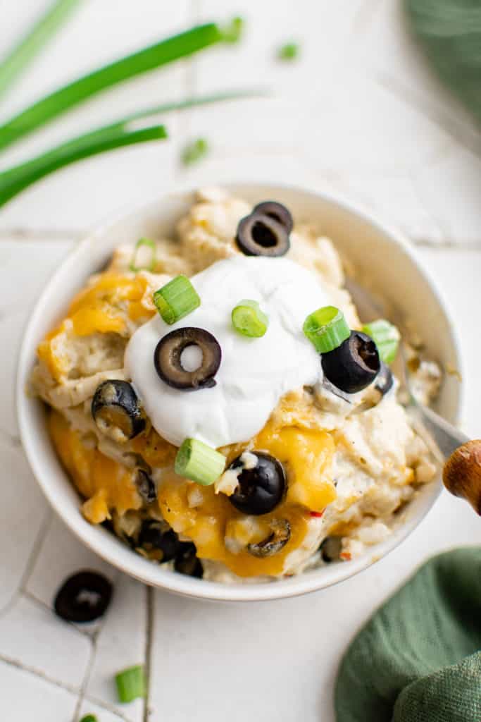 Close up view of a bowl of green chile chicken casserole.