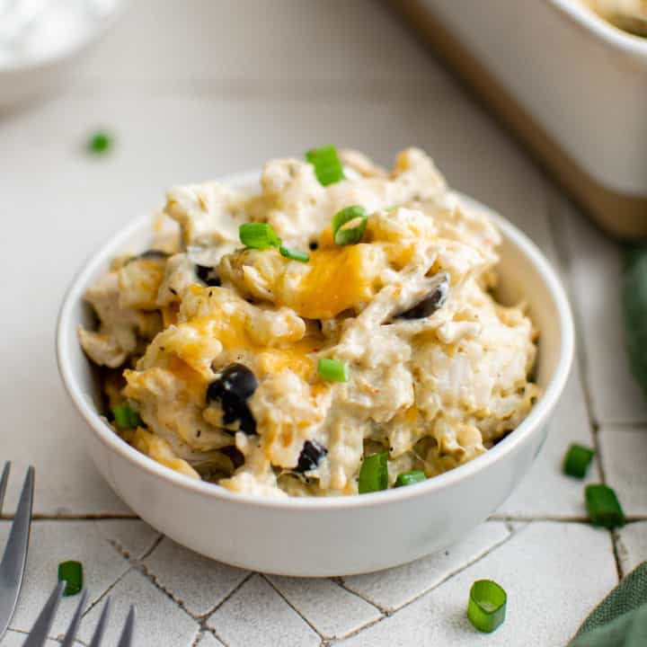 White serving dish filled with green chile chicken casserole.