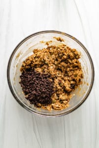 Chocolate chips added to granola bar mixture.