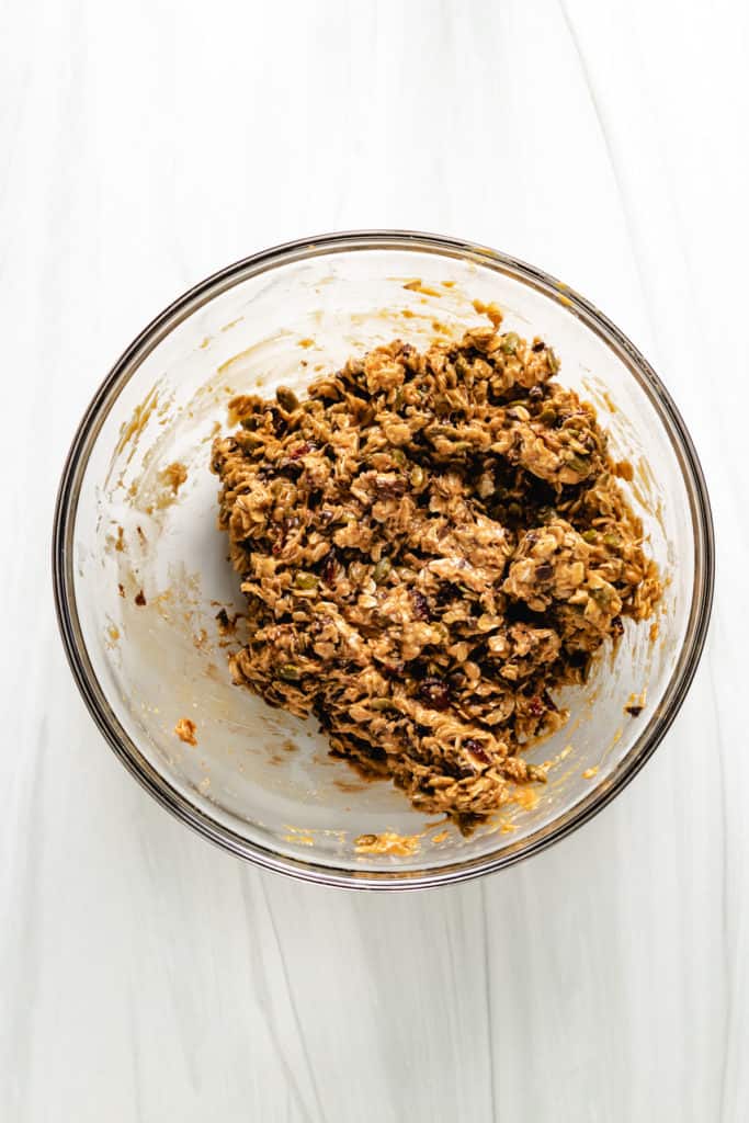 Granola bar mixture in a glass bowl.