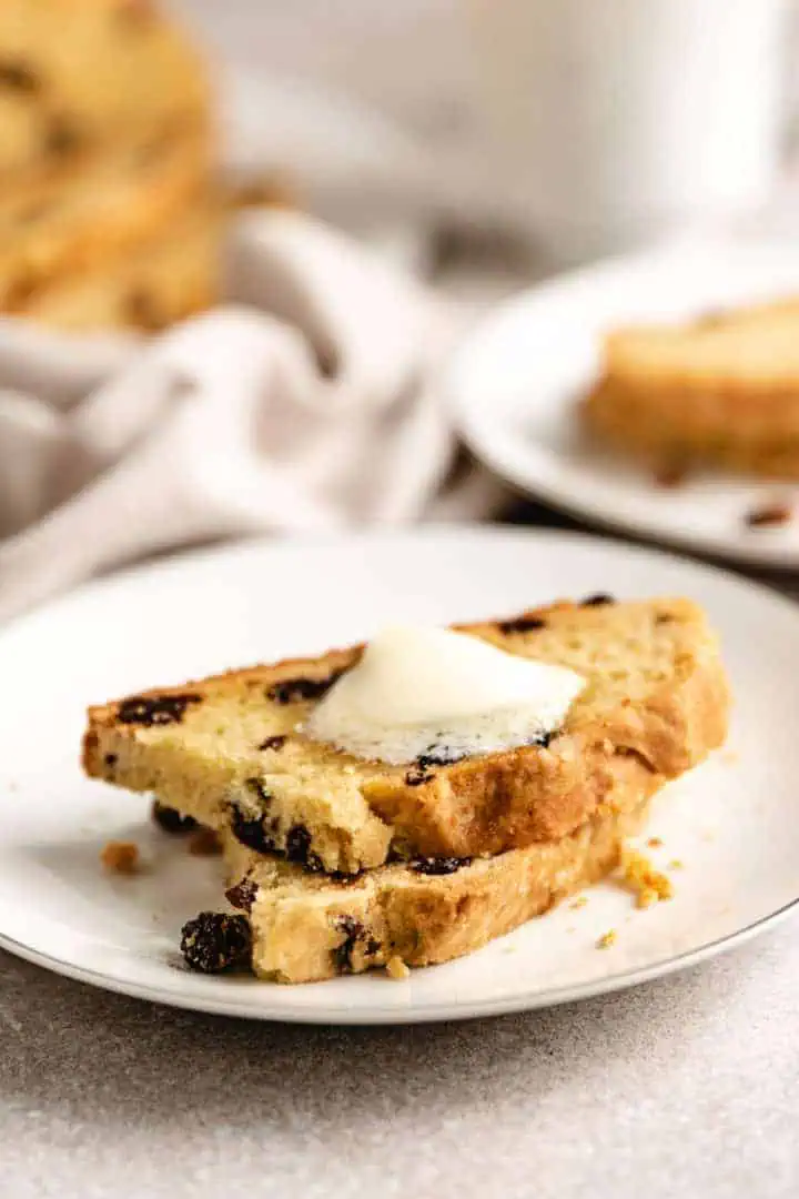 Two slices of irish soda bread on a white plate.