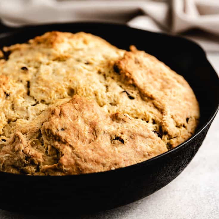 Cast iron skillet with a loaf of irish soda bread.