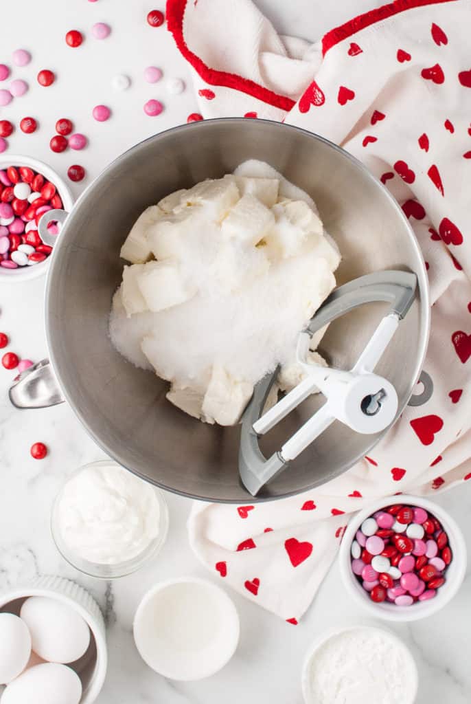 Cream cheese and sugar mixed together in a bowl.