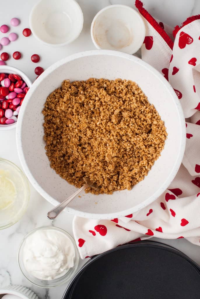 Graham cracker crumbs with sugar and butter in a bowl.