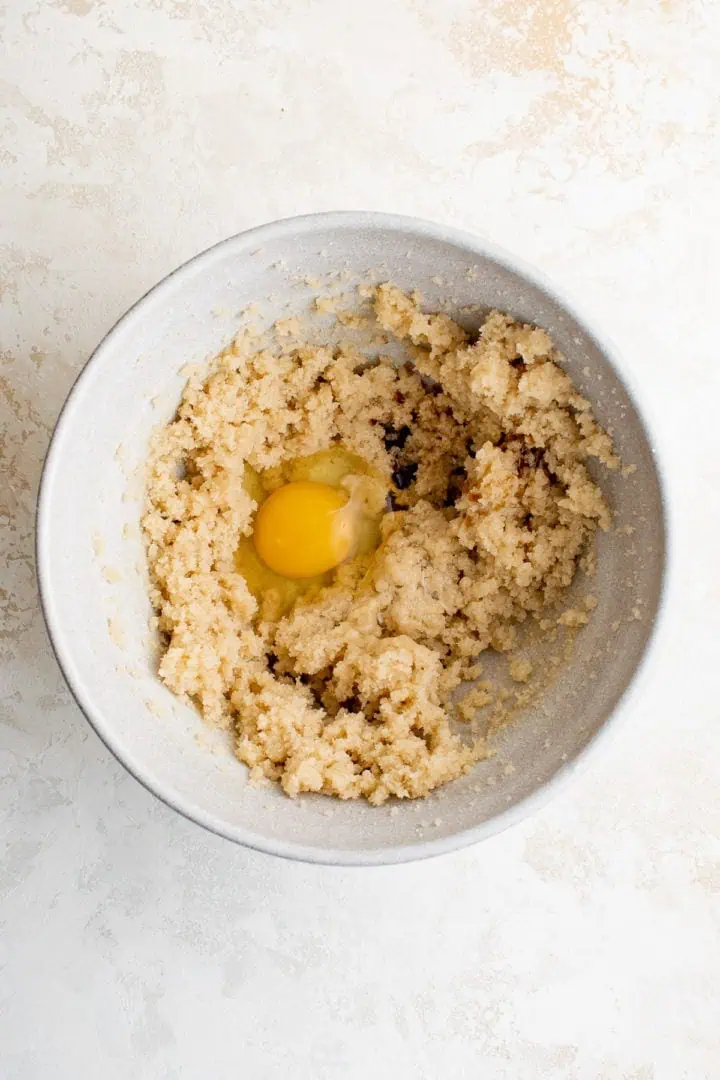 Egg and vanilla added to creamed butter and sugar.
