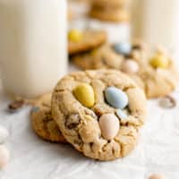 Mini egg cookies next to milk bottles.