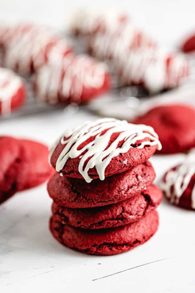 Four red velvet cookies in a stack.