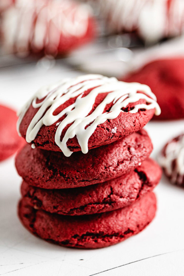 Four red velvet cookies in a stack.