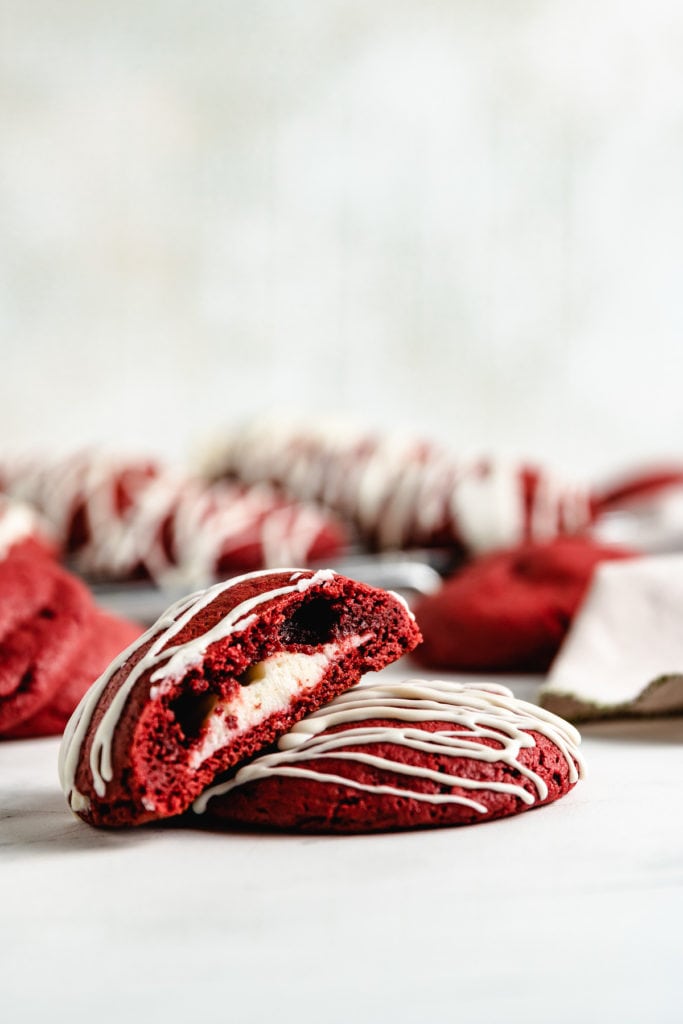 Two red velvet cake mix cookies stacked against each other.