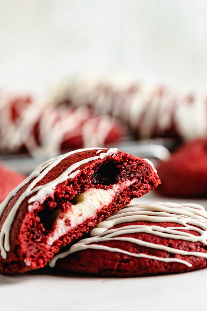 Two red velvet cake mix cookies stacked against each other.