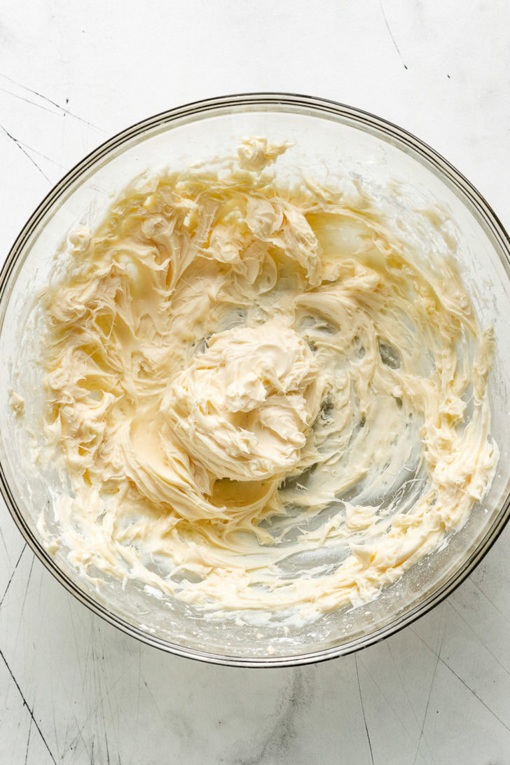 Cream cheese frosting mixed in a bowl.