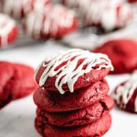 Four red velvet cake mix cookies in a stack.