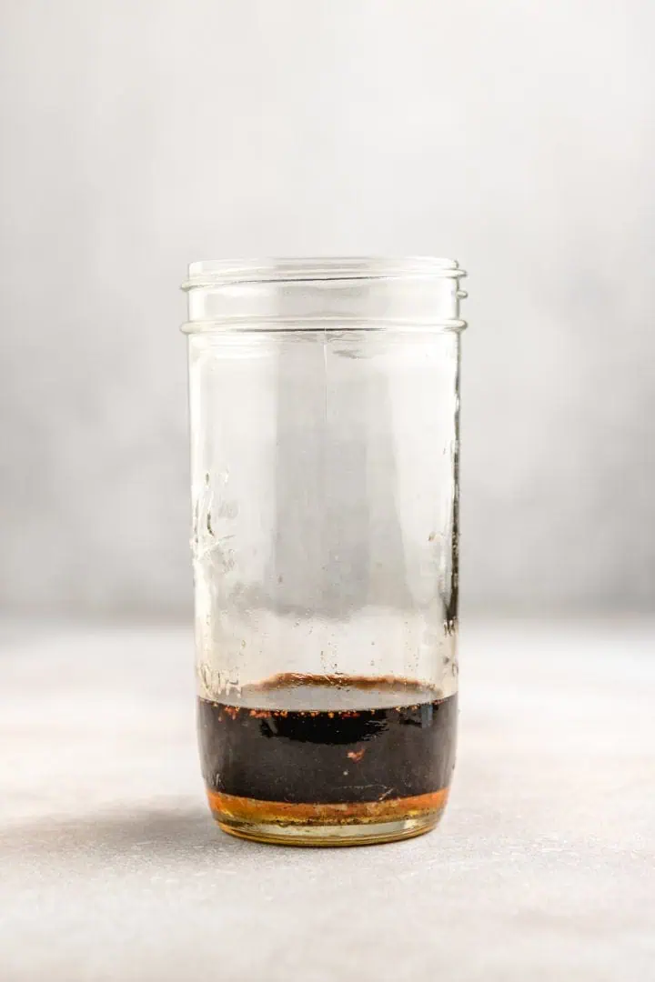 Balsamic vinegar in a jar of seasonings.