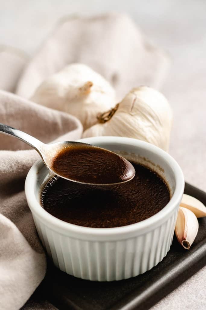 Small ramekin filled with balsamic vinaigrette.