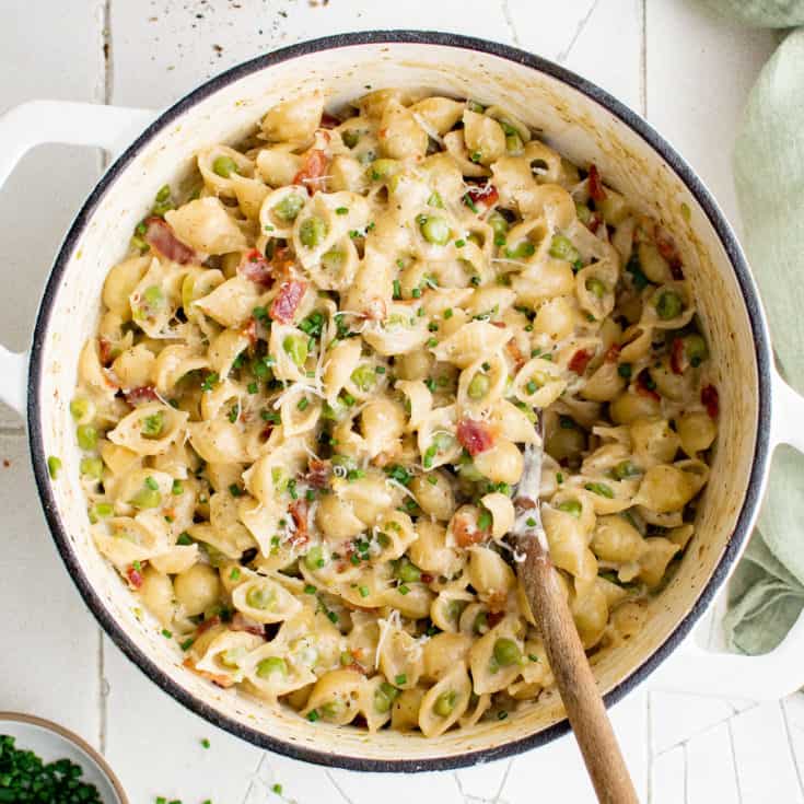Large pot filled with pasta and peas.