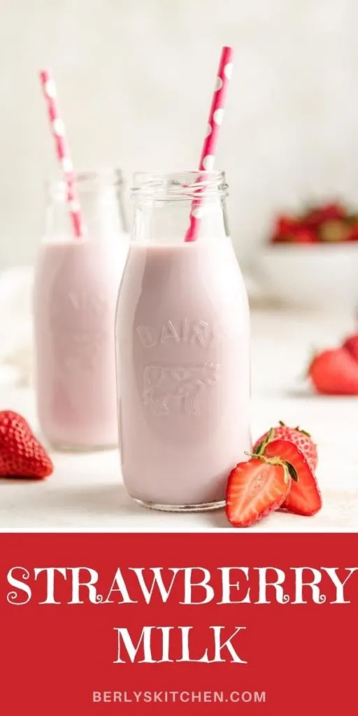 Two small jars of strawberry milk with straws.