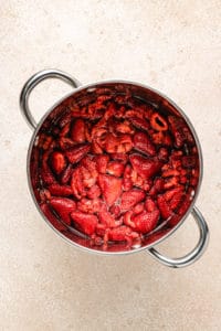 Mashed strawberries in a pan.