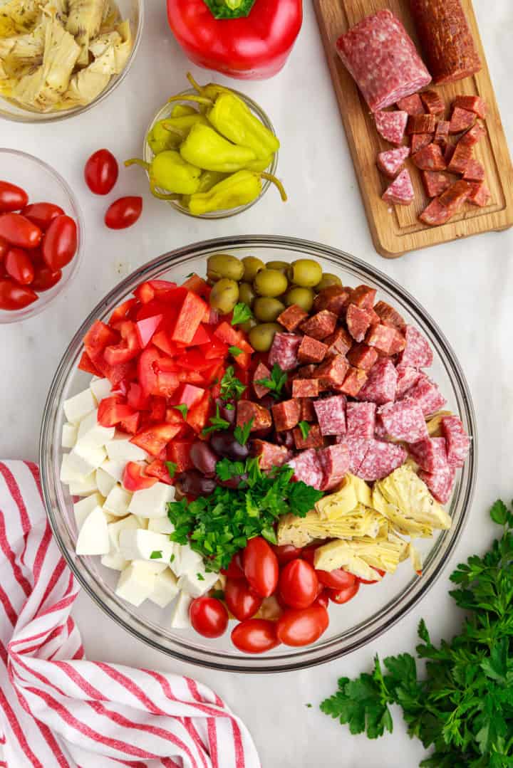 Ingredients for Italian pasta salad in a bowl.
