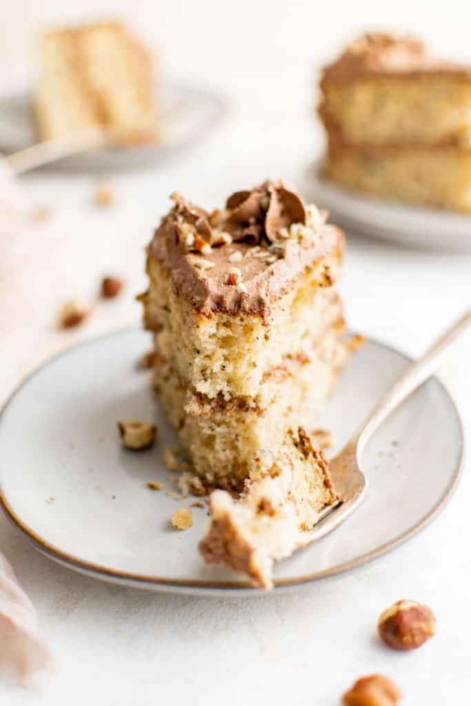 Hazelnut cake on a plate with a fork.