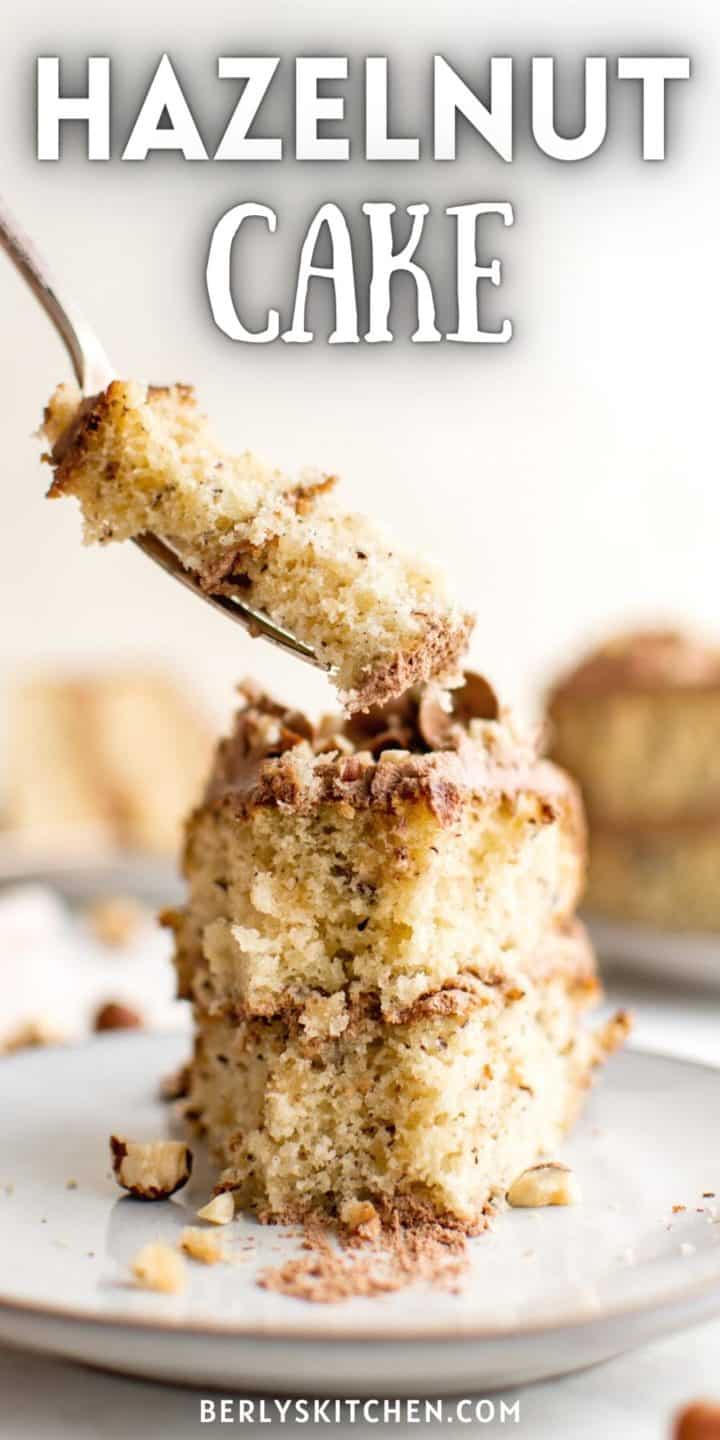 Fork taking a bite of hazelnut cake.