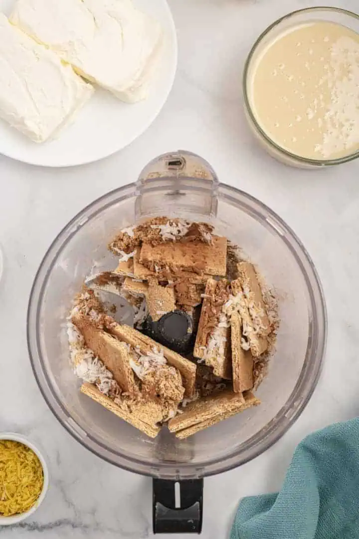Graham cracker, ginger, coconut, and brown sugar in a food processor.