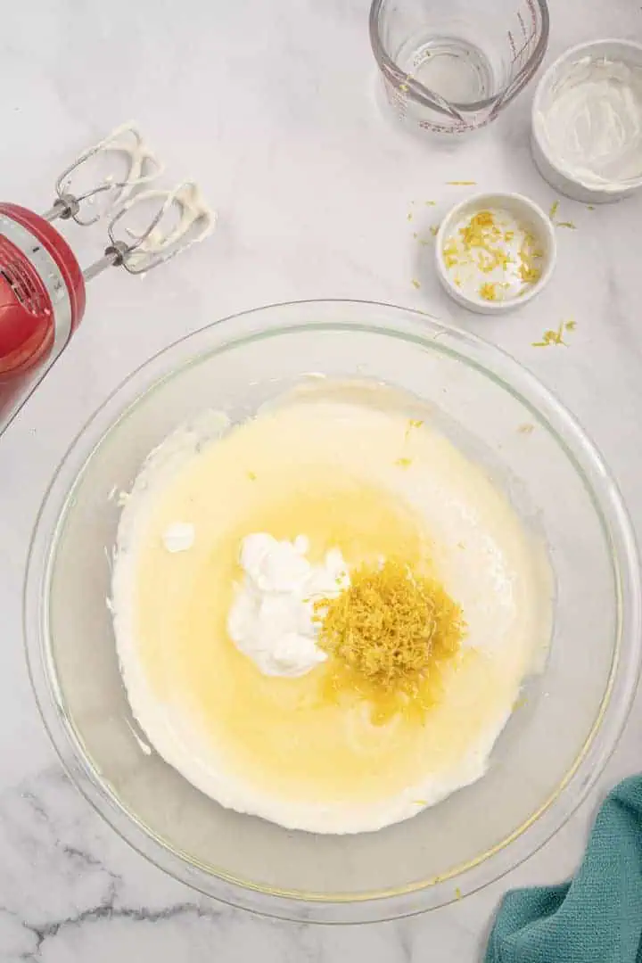 Sour cream, lemon juice, and lemon zest on top of sweetened cream cheese.