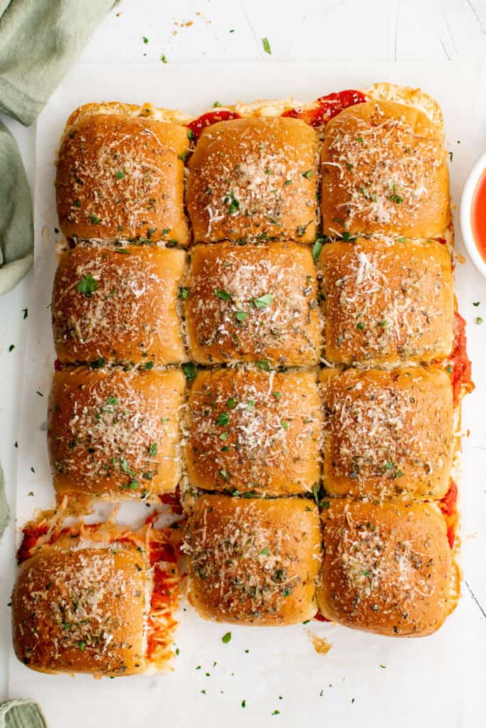 Top down view of a batch of sliders on a pan.